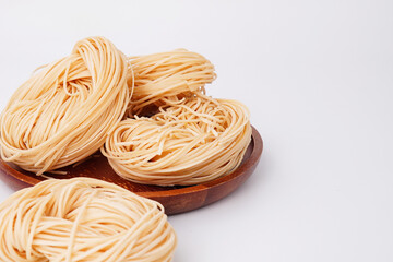 Yellow noodles flour raw materials for cooking on a white background