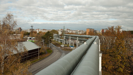 pipeline, in the photo the pipeline is close-up, in the background the city and buildings