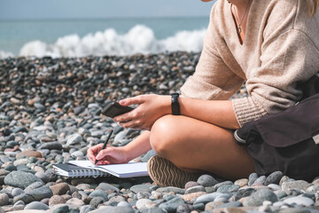 Remote work.Girl freelancer works remotely on the sea shore. workation, remote work,WFVH,Van Life vibes work from vacation home,work travel,remotely work.Travelling.Work from vacation remotely