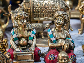small metal statues of traditional indian men which is playing musical instruments