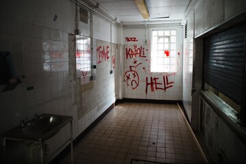 Prison hall with Hell writing on the wall