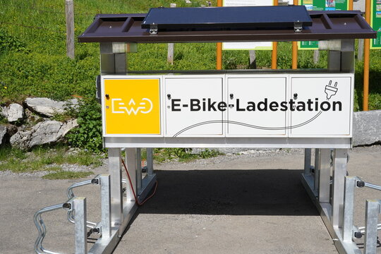 Melchsee, Switzerland 06 18 2022,  E-bike charging stations, in German e-bike ladestation, on the peak of the mountain near the offroad bicycle line. On the roof of station is solar panel.
