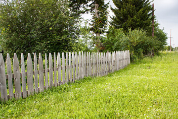 rural landscape with wooden fence on meadow