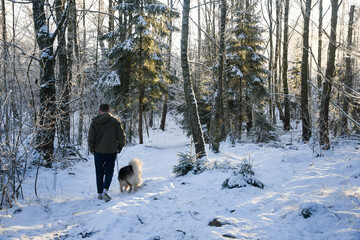 A man walking a dog in winter season