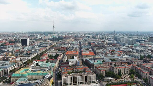 Aerial cityscape flying over downtown Berlin roof top view of houses and central district buildings ft urban skyline drone shot of Friedrichswerder neighborhood and Mitte central borough in Germany