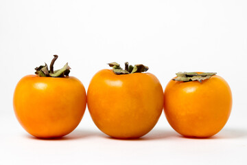 Persimmon on a white background. Ripe and tasty fruit