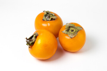 Persimmon on a white background. Ripe and tasty fruit