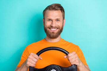 Photo of funky brown hairdo guy drive car wear orange t-shirt isolated on turquoise color...