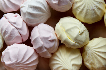 Freshly packaged multicolored air marshmallow according to a classic recipe at a confectionery factory, lies for sale to customers