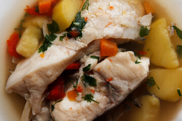 Traditional delicious savory fish soup served hot on a plate for lunch