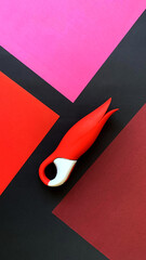 Sex toy for women. Red vibrator on a black background. Useful for adult, sex shop