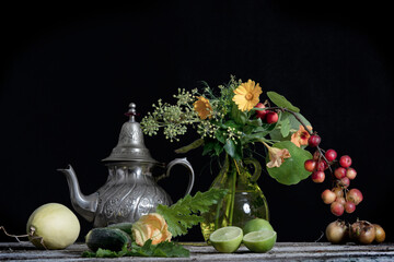 Still Life image of flowers and fruits in a vase.