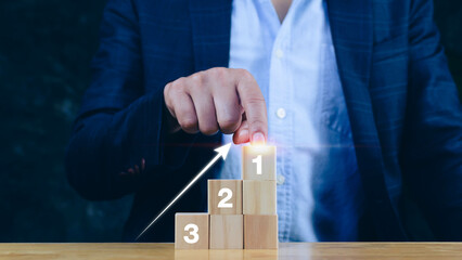Businessman  hand choose the wooden block with number 1 sign and up arrow, Concept of success...