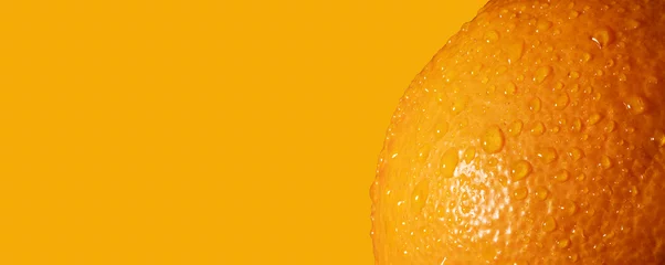 Muurstickers Fresh orange fruit skin close up. Ripe orange texture with water drops on orange background. Banner, copy space © photo-lime