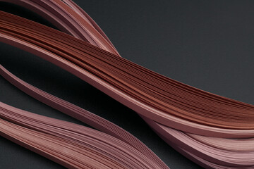 Beige brown color strip wave paper on black. Abstract texture background.
