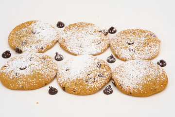 cookies arranged with chocolate chips isolated on white 