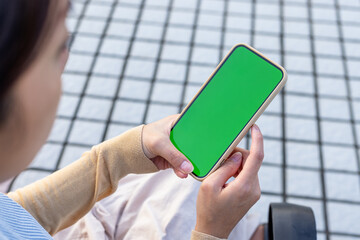 Woman use mobile phone with chroma key at outdoor