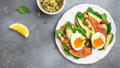 Toast salmon, avocado, cheese, egg, spinach, nuts and coffee, Healthy fats, clean eating for weight loss. Ketogenic diet breakfast. Long banner format. top view