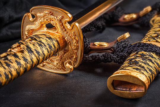 Japanese samurai katana sword and scabbard close up. Photo of a weapon in low key with selective focus