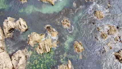 Aerial photo. A lot of boulders in the sea water, top view. Coastal cliffs of the North Atlantic. Seaside beautiful nature. Dramatic seascape of the north of Europe.