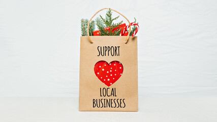 Support Local Business text written on paper shopping bag. Support Local Business quote, Christmas...