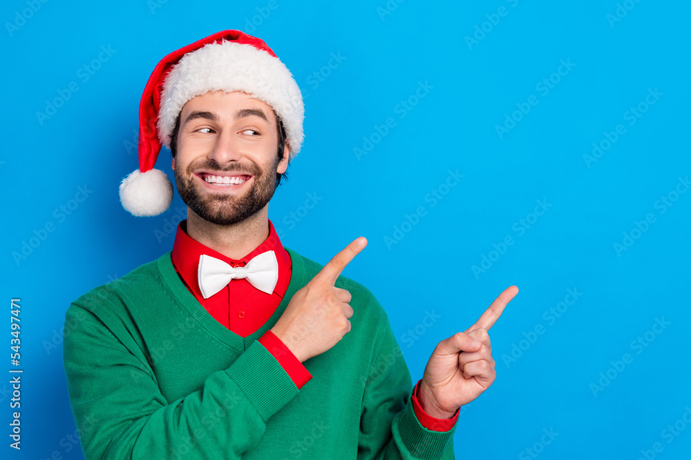 Poster photo of positive handsome guy look direct fingers empty space x-mas proposition isolated on blue co