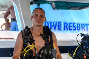 Male scuba diver preparing to dive. Wearing scuba. Caucasian man on dive boat.