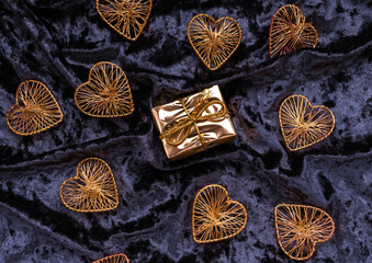 Christmas concept. On a purple velvet background, Christmas toys in the form of hearts with a place for text. Postcard for the new year.