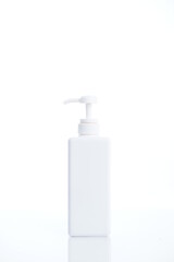 White cosmetic bottle dispenser pump with tube container from front angle isolated on white background.