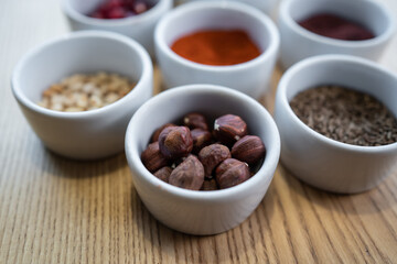 set of spices on wooden background, pomegranate, pine nut, hazelnut