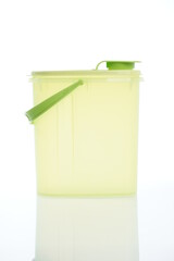 Modern green plastic pitcher isolated on white background.