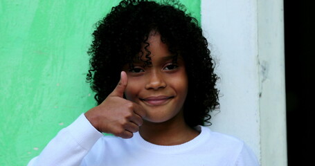 Positive child gives thumb up, confirmation positive