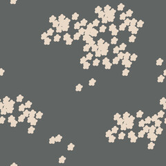 Small beige flowers on the grey background, seamless pattern.