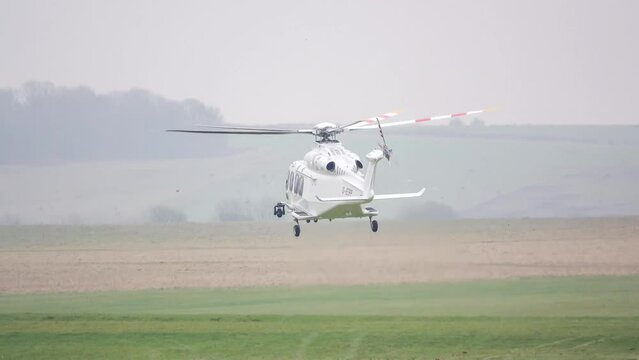 Agusta Westland AW139 military helicopter G-ETPP ETPS hovering just above grass, before transition to rapid flight and ascent, Wiltshire UK