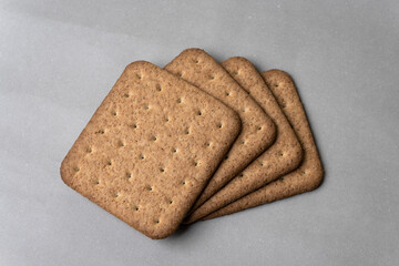 whole wheat healthy biscuits slices closeup top down view  on gray background