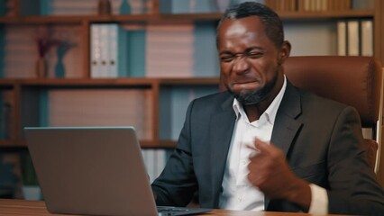 Joyful businessman checking email reading good news on laptop excited happy man leader rejoices in victory celebrating success gets new opportunity great investment proposal achieves desired result