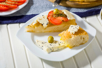 focaccia with tomatoes, cheese, olive oil and other additions