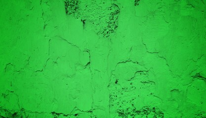 A textured green grunge background with dark patches and rough surface
