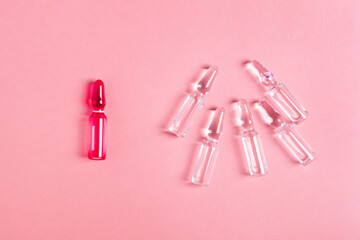 Ampoules for injections for health and beauty, B vitamins in glass , women's health on a pink background