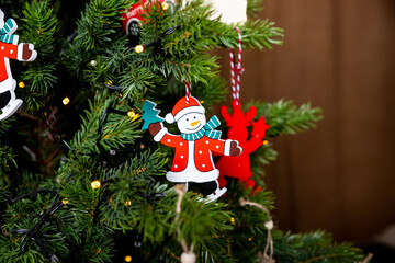 white Christmas angel on a tree. Wooden angel on the Christmas tree. festive background with christmas toy