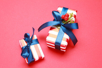 Wallpaper greeting card Merry Christmas holiday composition with striped red blue white gift box present decoration on red color background. Xmas New Year winter design idea concept. 