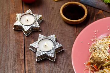 Candles for Shabbat on the table ready for a festive meal.