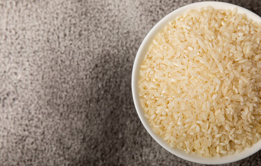 Healthy food. A bowl of steamed rice on a black marble background. Place for text, copy space. Diet porridge.
