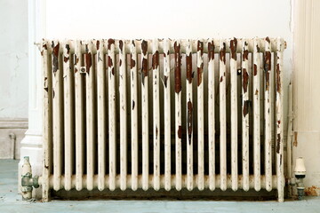 Antique radiator with peeling paint.