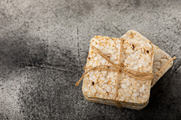 Round rice cakes on a  black table. Crispbread.Puffed rice bread. diet crispy round rice cakes.Place for text. Place for copy. Healthy food. dietary product.