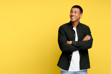 Happy successful man posing with happy confident expression, keeping arms folded