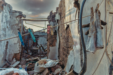 life in mariupol clothesline with clothespins on the background of a house destroyed by war