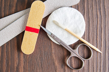 Flat lay template with manicure tools, scissors, nail file, cotton pad on the worker table. Health...