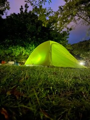 tent in the forest with a light inside overnight 