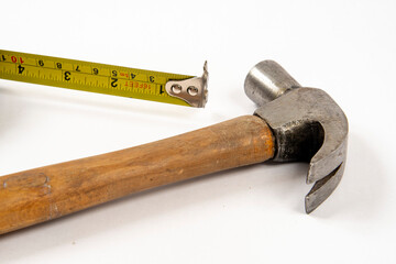 yellow tape measure and hammer